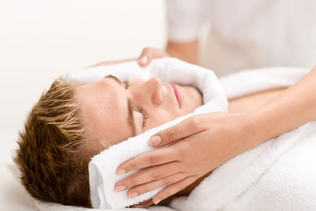 A man receiving a relaxing facial treatment for rejuvenated skin.